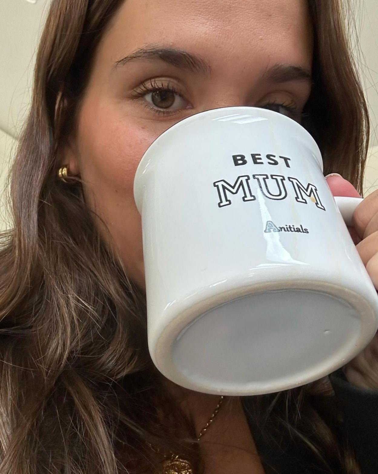 beautiful fashion model drinking coffee in a cup